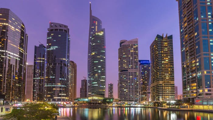 Carpenter using tools for fine detailing in JLT Dubai workshop